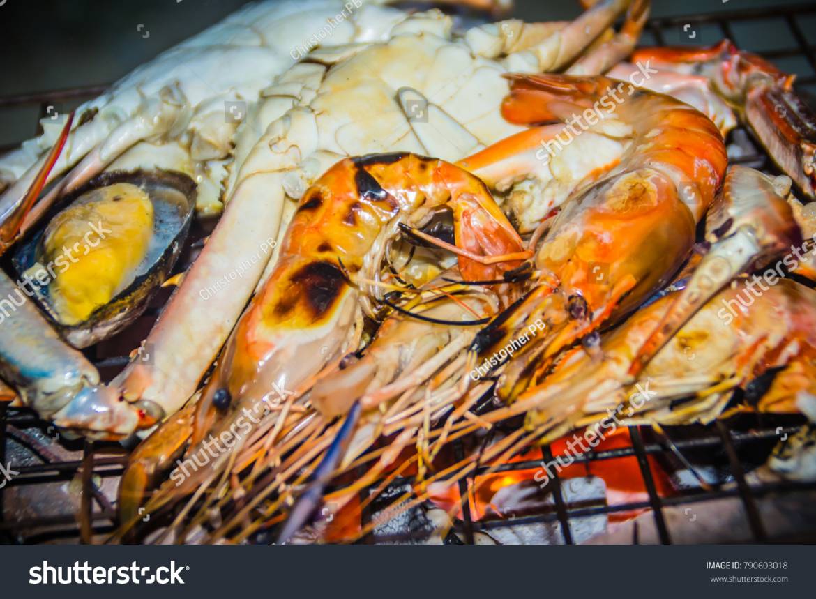 stock-photo-close-up-grilled-crabs-and-shrimps-on-fire-charcoal-stove-at-night-party-seafood-barbecue-party-790603018.jpg